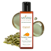 Mystiq Living Pumpkin Seed Oil bottle with seeds and oil droplets on a white background