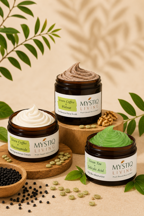 Three jars of MYSTIQ LIVING face products arranged on wooden stands with green leaves and coffee beans around them on a beige background.